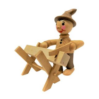 Gnome with saw on the sawhorse